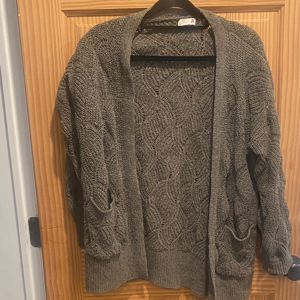 Open front long cardigan sweater with chevron like pattern .